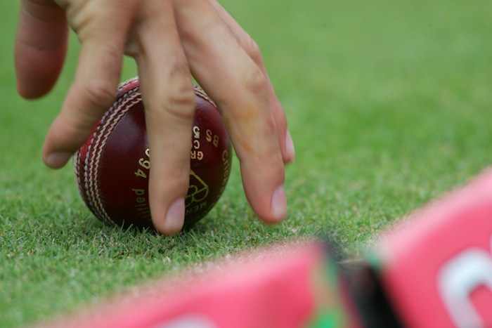 Hand on cricket ball